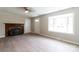 Bright, spacious living room featuring a charming fireplace and large window for natural light at 606 W 19Th Ave, Gastonia, NC 28052