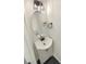 Charming half bathroom featuring a modern vanity and fixtures, complete with a sleek oval mirror and stylish lighting at 704 Georgie St, Troutman, NC 28166