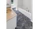 Elegant bathroom featuring tub, walk-in shower, marbled tile floors, and a vanity with a stone countertop at 704 Georgie St, Troutman, NC 28166