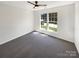 Inviting bedroom featuring neutral carpeting, natural light streaming in from a double window, and a modern ceiling fan at 704 Georgie St, Troutman, NC 28166