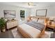 Cozy bedroom with neutral walls, ceiling fan, stylish furnishings, and natural light at 704 Georgie St, Troutman, NC 28166