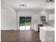 Bright kitchen with white cabinets, stainless steel appliances, island and sliding glass doors at 704 Georgie St, Troutman, NC 28166