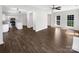 Open-concept living space showcasing wood flooring, stainless appliances, and natural light at 704 Georgie St, Troutman, NC 28166