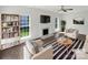 Bright living room with fireplace, neutral decor, and hardwood floors is virtually staged for a modern look at 704 Georgie St, Troutman, NC 28166
