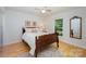 Charming bedroom with hardwood floors, a ceiling fan, natural light, and a decorative mirror at 7230 Ridge Lane Rd, Charlotte, NC 28262