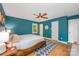 Bright bedroom featuring wood floors, neutral walls, ample lighting, and a comfortable king size bed at 7230 Ridge Lane Rd, Charlotte, NC 28262
