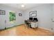 Bright bedroom with golf putting green, desk area, and serene view outside the window at 7230 Ridge Lane Rd, Charlotte, NC 28262
