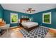 Comfortable bedroom with hardwood floors, a ceiling fan, natural light, and a decorative rug at 7230 Ridge Lane Rd, Charlotte, NC 28262