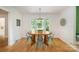 Bright dining room with hardwood floors, stylish light fixture, and a bay window at 7230 Ridge Lane Rd, Charlotte, NC 28262