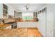 Well-lit kitchen with white cabinets, tiled countertops, and modern appliances at 7230 Ridge Lane Rd, Charlotte, NC 28262
