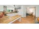 Well-lit kitchen with white cabinetry, tile countertops, and hardwood floors at 7230 Ridge Lane Rd, Charlotte, NC 28262