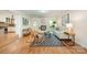 Bright living room with fireplace, wood floors, modern decor, and an open layout to the kitchen at 7230 Ridge Lane Rd, Charlotte, NC 28262