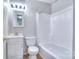 Clean bathroom with white fixtures, including a vanity, toilet, and tub-shower combo, well-maintained at 817 32Nd Street Ne Dr, Conover, NC 28613