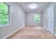 Neutral bedroom with carpet and ample natural light from two windows overlooking greenery at 817 32Nd Street Ne Dr, Conover, NC 28613