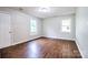 Bright bedroom with wood floors, two windows, neutral walls, and a white door at 817 32Nd Street Ne Dr, Conover, NC 28613
