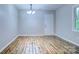 Bright dining area features wood floors, neutral paint, and a modern chandelier at 817 32Nd Street Ne Dr, Conover, NC 28613