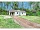Charming home with freshly cut lawn and dirt driveway surrounded by mature trees at 817 32Nd Street Ne Dr, Conover, NC 28613