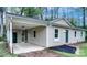 Charming single-story home featuring a covered parking area and freshly landscaped yard at 817 32Nd Street Ne Dr, Conover, NC 28613
