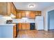 Functional kitchen featuring wood cabinetry, a black range, and laminate floors for a cozy feel at 817 32Nd Street Ne Dr, Conover, NC 28613