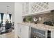White bar area with granite counters, wine cooler, and cabinetry at 8903 Ansley Park Pl, Huntersville, NC 28078