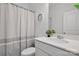 Bright, clean bathroom with a modern vanity, sleek fixtures, and a shower with a curtain at 8903 Ansley Park Pl, Huntersville, NC 28078