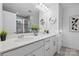 This bathroom features dual sinks, quartz countertops, and a tiled shower at 8903 Ansley Park Pl, Huntersville, NC 28078
