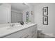 A clean bathroom with a double sink vanity and framed artwork at 8903 Ansley Park Pl, Huntersville, NC 28078