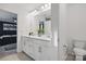 This bathroom features dual sinks, quartz countertops, and an adjacent bedroom at 8903 Ansley Park Pl, Huntersville, NC 28078