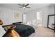 This bedroom features neutral walls, a ceiling fan, and an ensuite bathroom at 8903 Ansley Park Pl, Huntersville, NC 28078