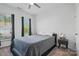 Cozy bedroom with a comfortable bed, soft lighting, and windows overlooking the yard at 8903 Ansley Park Pl, Huntersville, NC 28078