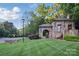 Charming stone entrance to the Olmsted community with manicured lawns and greenery at 8903 Ansley Park Pl, Huntersville, NC 28078