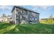 A gray two-story house with a well-maintained lawn, grill, and air conditioning unit at 8903 Ansley Park Pl, Huntersville, NC 28078