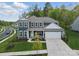 Charming two-story home with a well-manicured lawn, attached garage, and inviting front porch at 8903 Ansley Park Pl, Huntersville, NC 28078