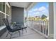 Relaxing front porch featuring cozy seating and a view of the neighborhood at 8903 Ansley Park Pl, Huntersville, NC 28078