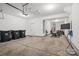 This garage features a high ceiling, a side door, and space for gym equipment at 8903 Ansley Park Pl, Huntersville, NC 28078