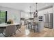 Bright kitchen featuring stainless steel appliances, granite countertops, and access to the breakfast nook at 8903 Ansley Park Pl, Huntersville, NC 28078