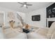 Living room featuring hardwood floors, neutral paint, a TV, and staircase access at 8903 Ansley Park Pl, Huntersville, NC 28078