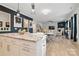Open concept kitchen with island and breakfast bar, overlooking living room and fireplace at 8903 Ansley Park Pl, Huntersville, NC 28078