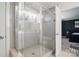 This shower features a glass door, a tiled wall, and great lighting at 8903 Ansley Park Pl, Huntersville, NC 28078