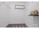 This walk-in closet offers wire shelving for storage and an art piece for decoration at 8903 Ansley Park Pl, Huntersville, NC 28078