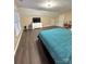 Bright bedroom with dark wood floors, natural light, and a comfortable teal bedspread at 9003 Brad Ct, Matthews, NC 28104