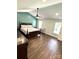 Spacious bedroom featuring ample natural light, dark wood floors, and a ceiling fan at 9003 Brad Ct, Matthews, NC 28104