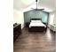 Inviting bedroom with ample space, dark wood floors, and a well-lit ambiance at 9003 Brad Ct, Matthews, NC 28104