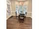 Cozy dining room with wood floors, a glass-top table, and natural light at 9003 Brad Ct, Matthews, NC 28104