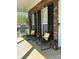 Inviting front porch with brick accents and comfortable seating arrangement at 9003 Brad Ct, Matthews, NC 28104