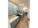 The kitchen has stainless steel appliances, granite countertops, and blue cabinets at 9003 Brad Ct, Matthews, NC 28104