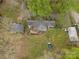 Aerial view of house, deck, storage buildings, and yard with mature trees at 9216 Caycee Dr # 32, Davidson, NC 28036