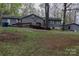 View of home featuring accessible ramp to entrance, lawn, and mature trees at 9216 Caycee Dr # 32, Davidson, NC 28036