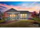 A covered patio overlooks the lush backyard, providing an ideal space for relaxation and entertainment at 953 Kirby Dr, Fort Mill, SC 29715