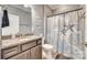 Cozy bathroom featuring a granite-topped vanity and coastal-themed shower curtain at 953 Kirby Dr, Fort Mill, SC 29715